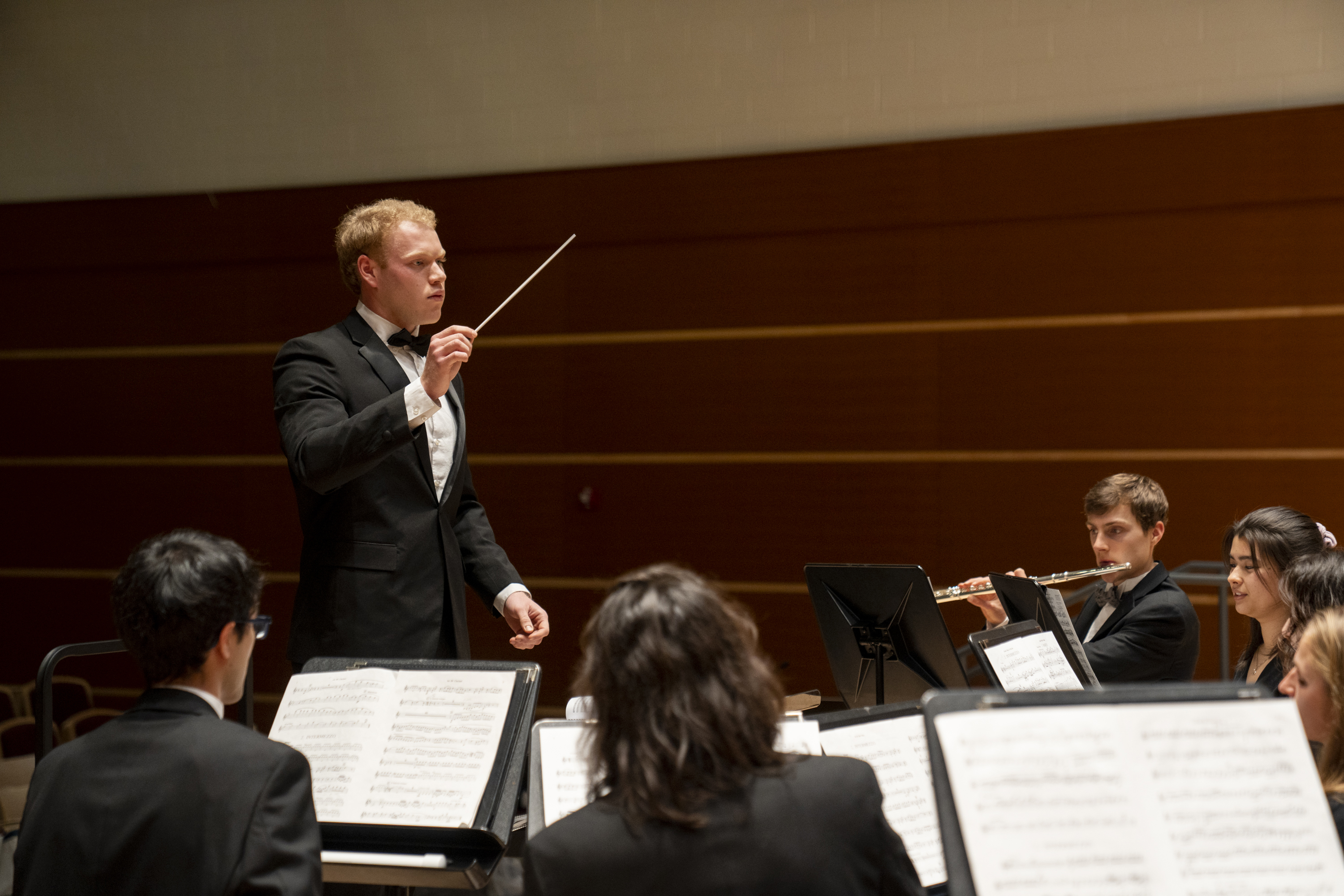 Daniel Chandler '25 conducts the University Wind Ensemble during a rehearsal.